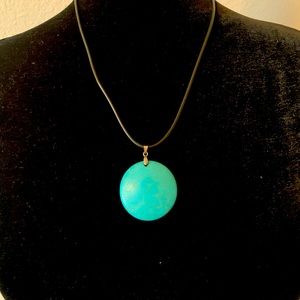 Teal pendant on black cord necklace